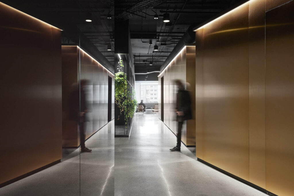 the shiny hallway with concrete flooring in the office of 2K, a video game publisher