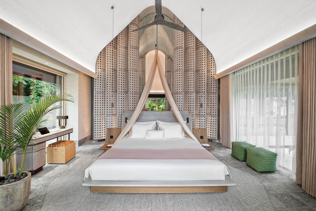 a luxurious canopy bed in a guest room of Joali Being, a boutique hotel in the Maldives