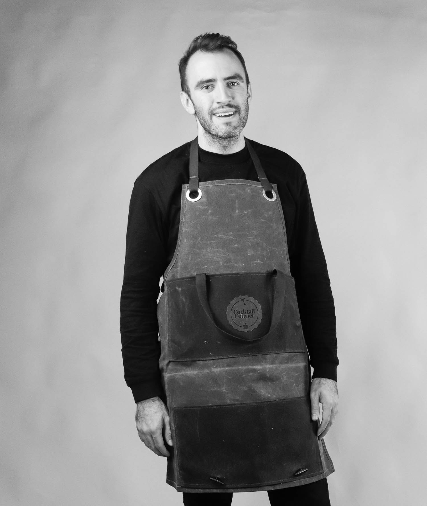 A black and white image of Matthew Kedzierski in an apron. 
