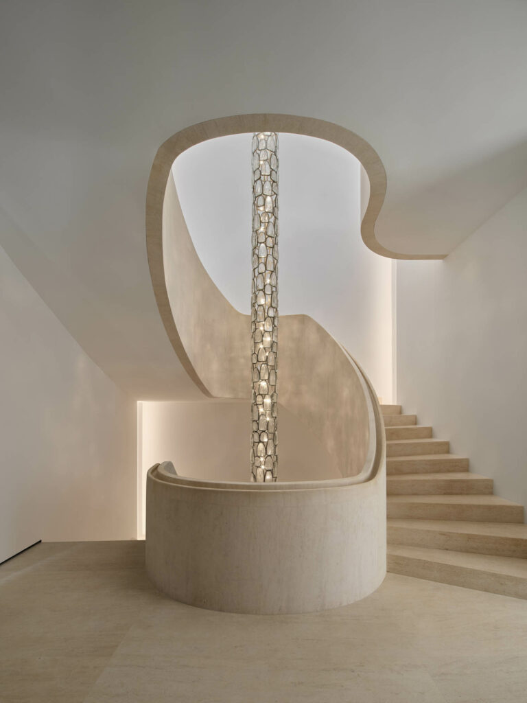 a cut glass pendant in the middle of a hand-carved stone staircase
