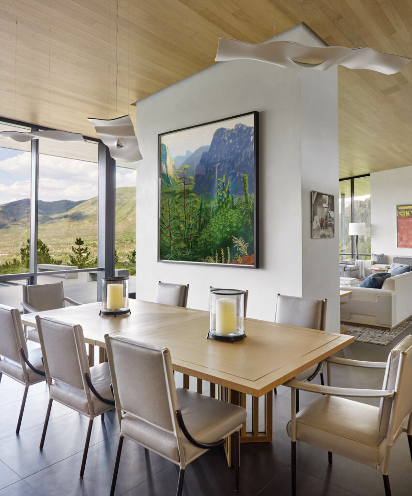 the dining room of an Aspen home with mountain views out the windows