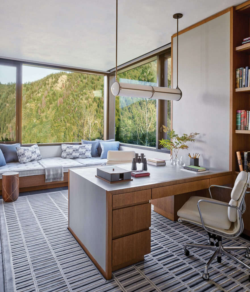a daybed and desk are made of white oak in this home's study