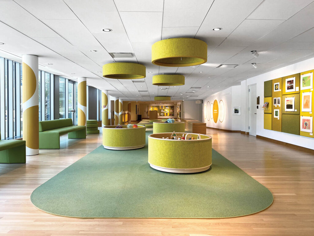 yellow circular storage under yellow lighting fixtures in a lounge area of the Denver Art Museum 
