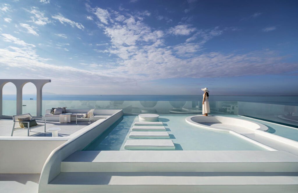 a woman stands on the terrace of the Sanya boutique hotel with skyline views