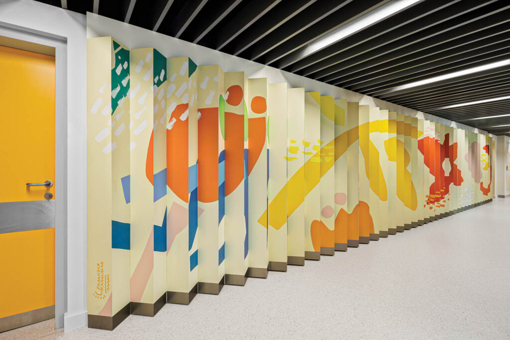 a colorful mural on the wall of a children's wing of a hospital