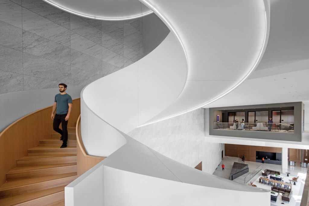 A three-story staircase of Corian-clad steel and white oak forms the center­piece of the Norfolk Southern Corporation headquarters in Atlanta, with interiors by HOK.