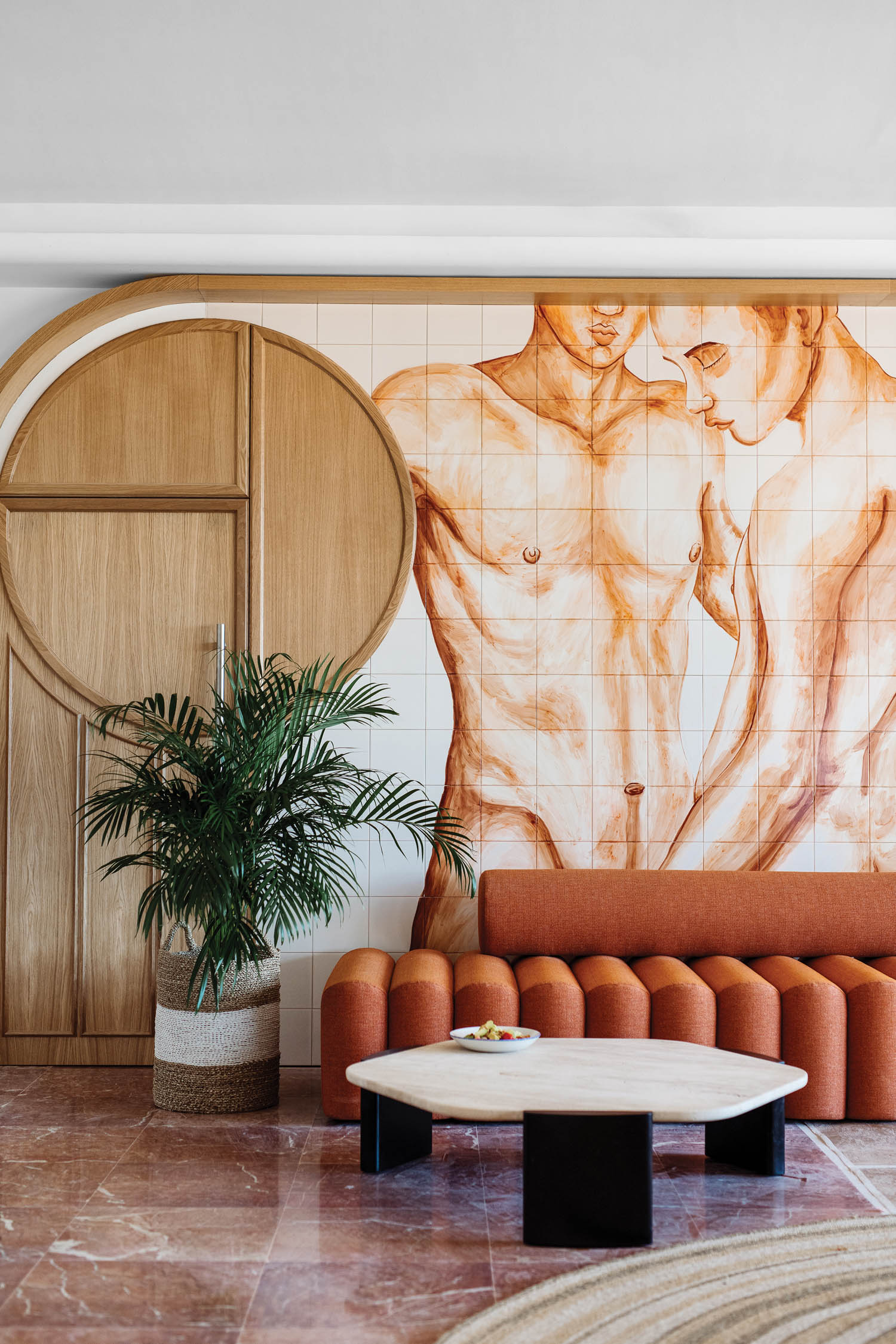 a porcelain-tile mural of nude beachgoers in the lobby of Hotel Riomar