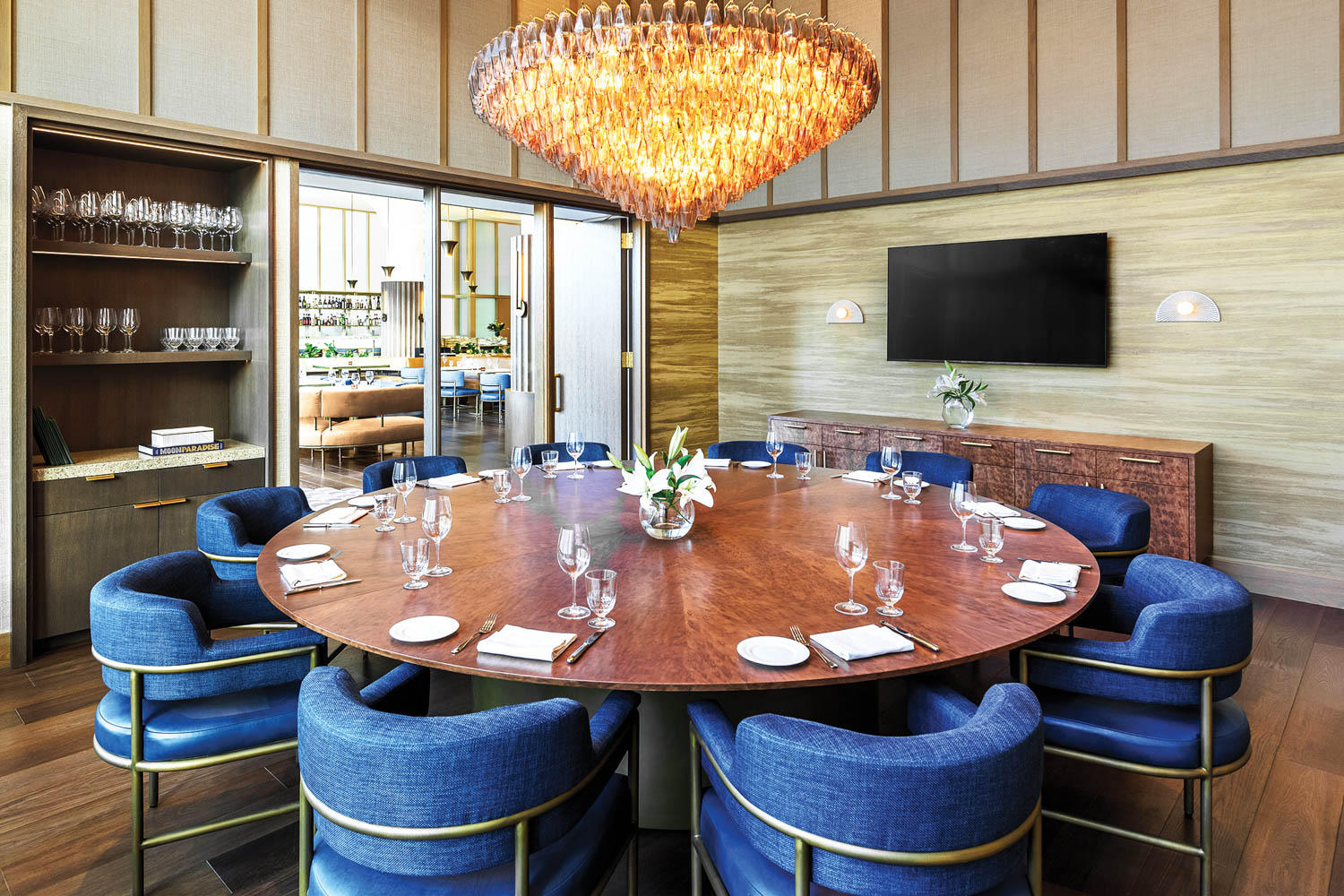 midnight blue chairs surround a dining table in Le Clou, a restaurant in The Morrow