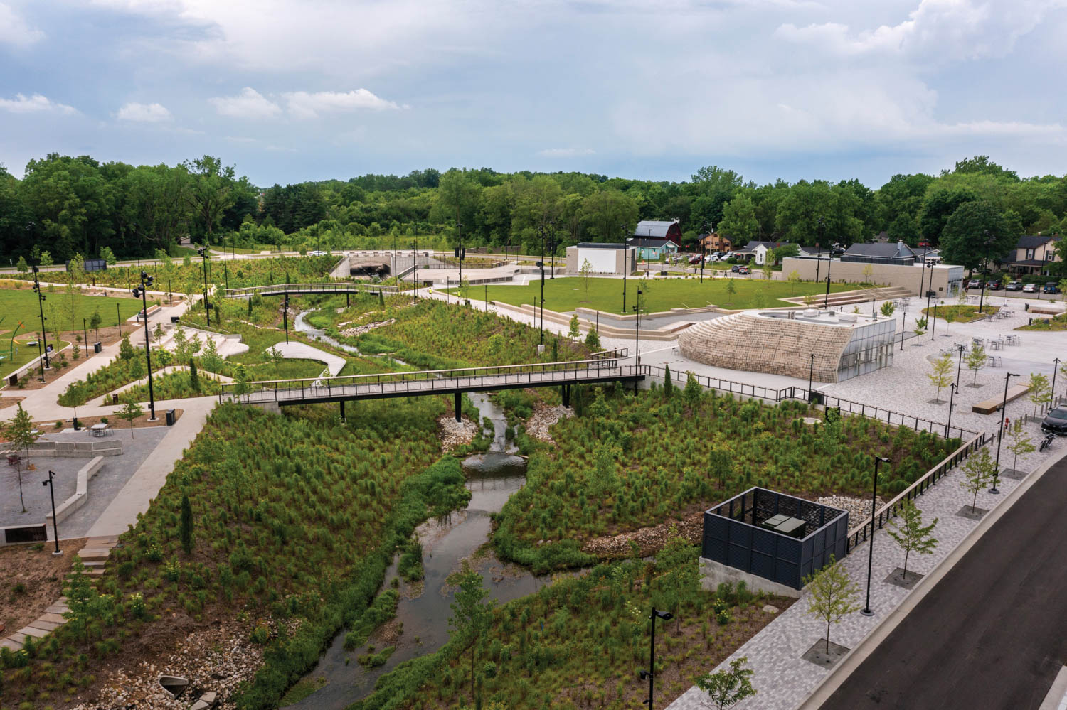 bridges connect grassy areas throughout an outdoor plaza