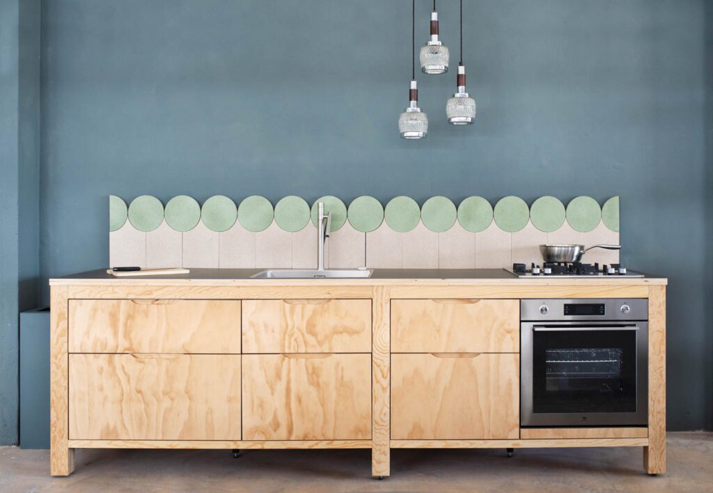 A kitchen counter backed by pastel green circles
