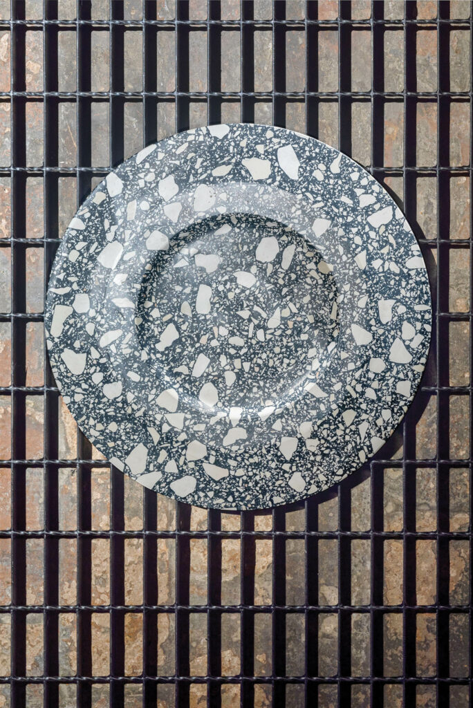 a gray and white terrazzo charger
