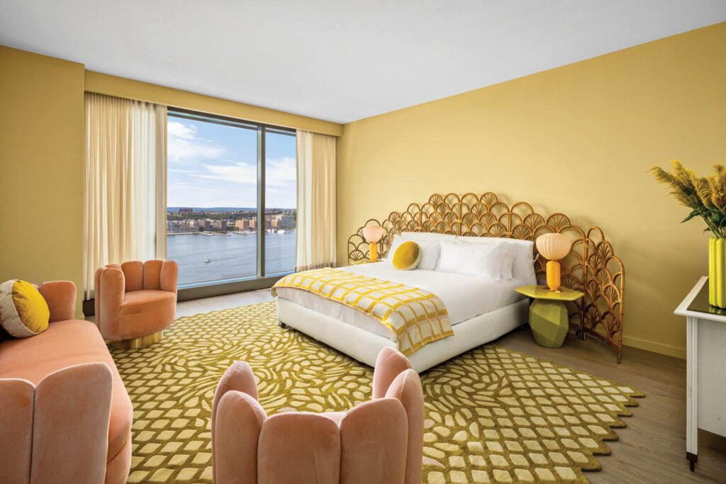 A bedroom with a yellow carpet and yellow walls