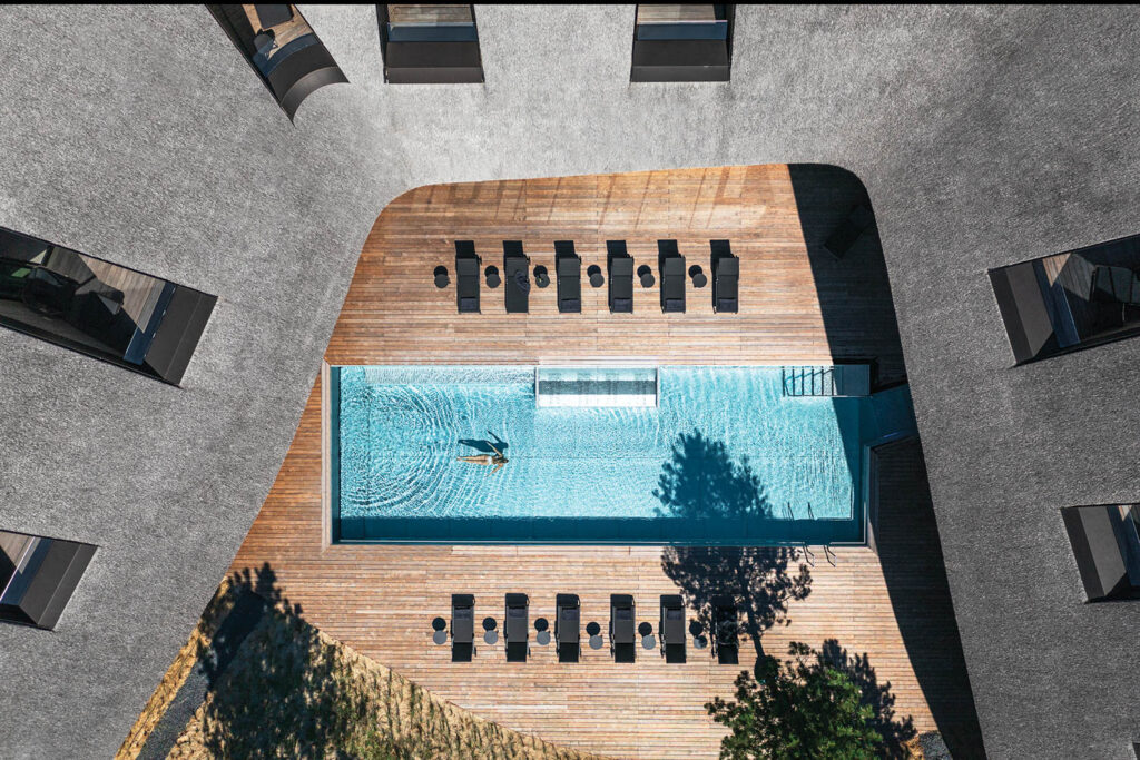 an aerial view of swimming pool at the center of a building