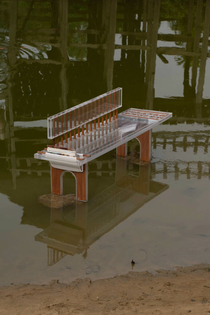 the Ayo bench by Josh Egesi sits in a puddle
