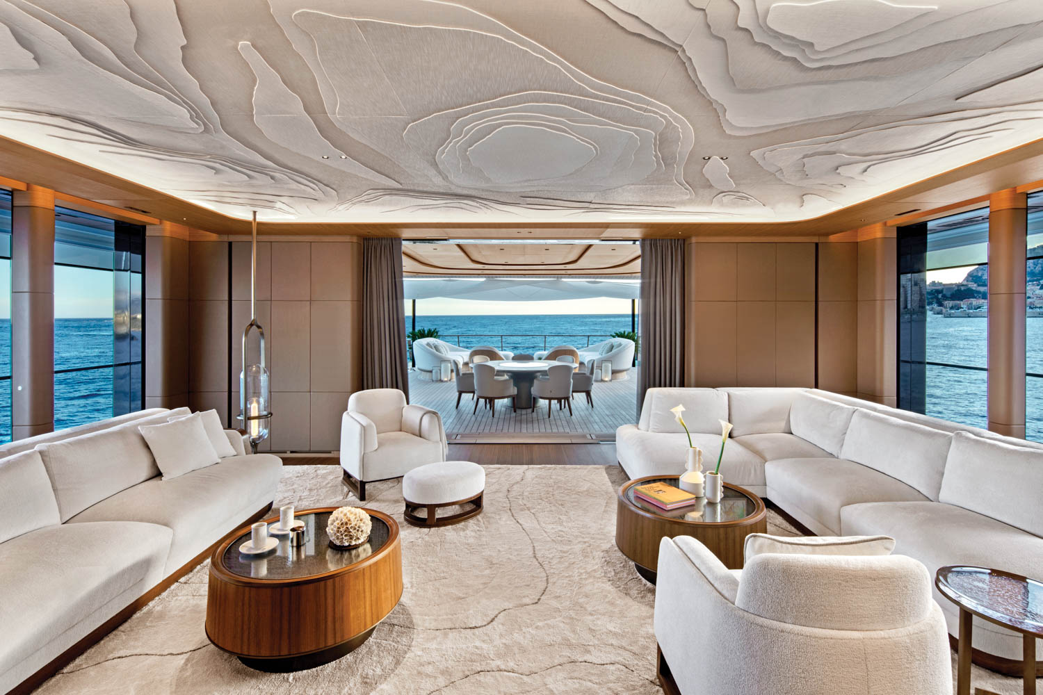 hydrographic map-inspired patterns on the ceiling and rug in a yacht's salon