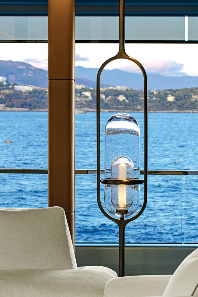 a custom lamp glows behind ocean views in this yacht