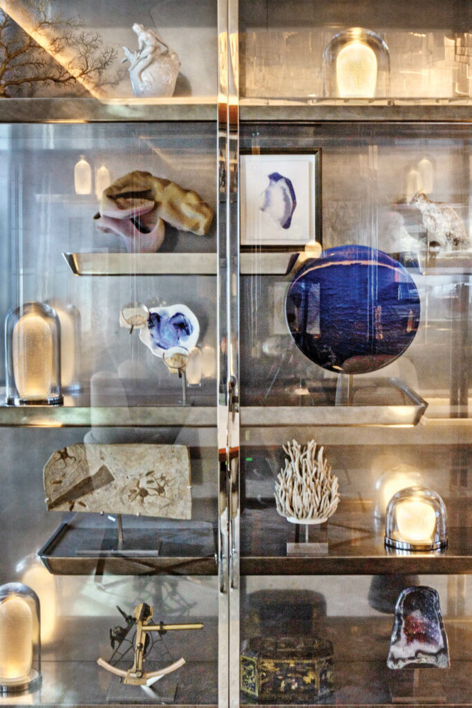 a cabinet of nautical trinkets in the dining room of a yacht