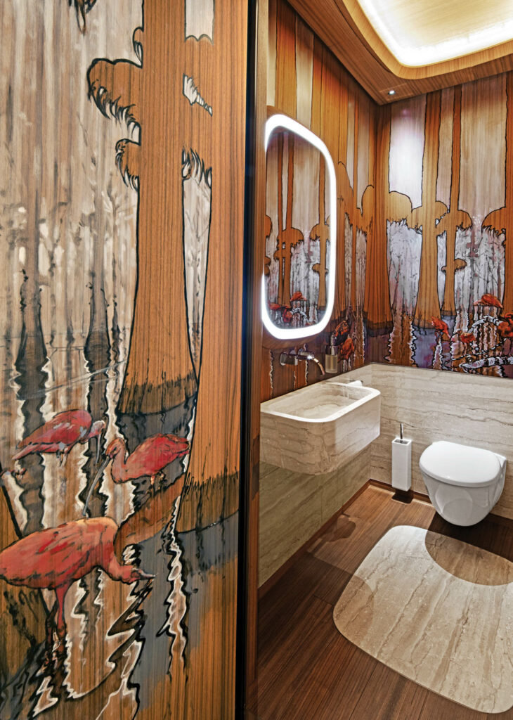 inside a powder room of a yacht with flamingos painted on the walls