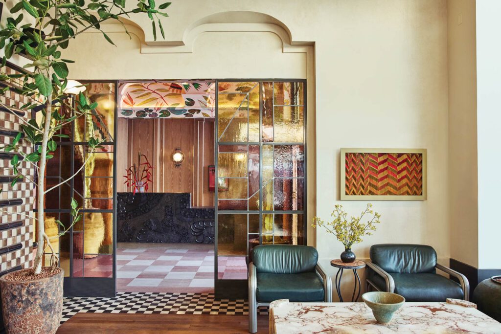 A stained-glass partition by Judson Studios marks the entry to Caldo Verde, the restaurant off the lobby. 