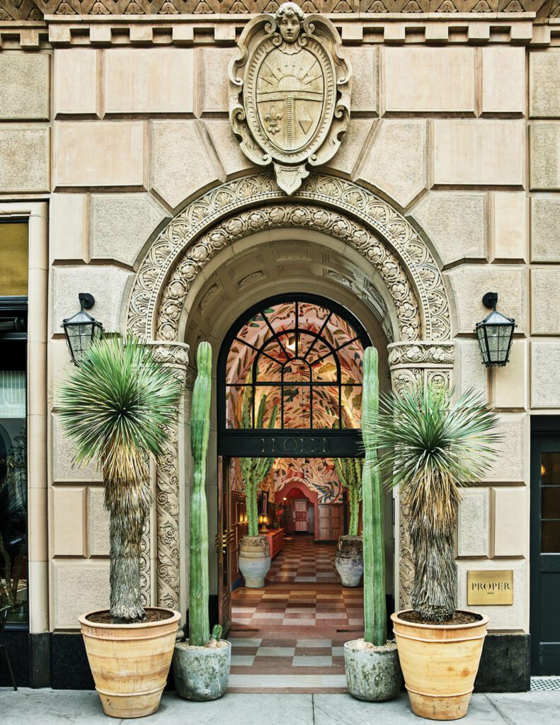 The landmarked limestone and terra-cotta facade incorporates an arched entrance framed with bas-relief, which influenced the design of the hotel’s interiors.