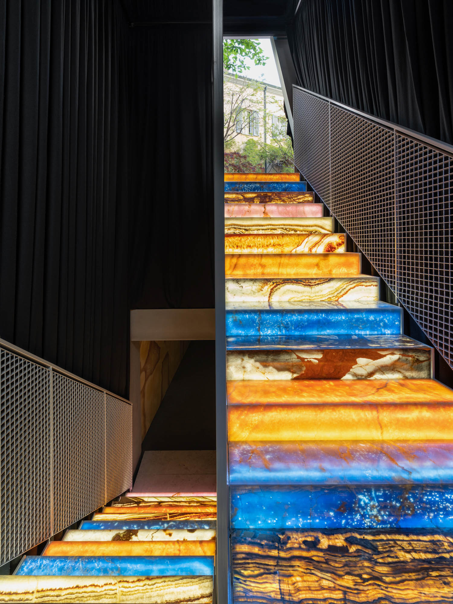 backlit stairs, each step a different color of onyx