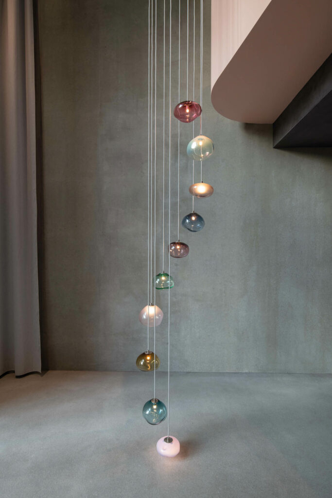 a pendant light made of colored spheres of glass