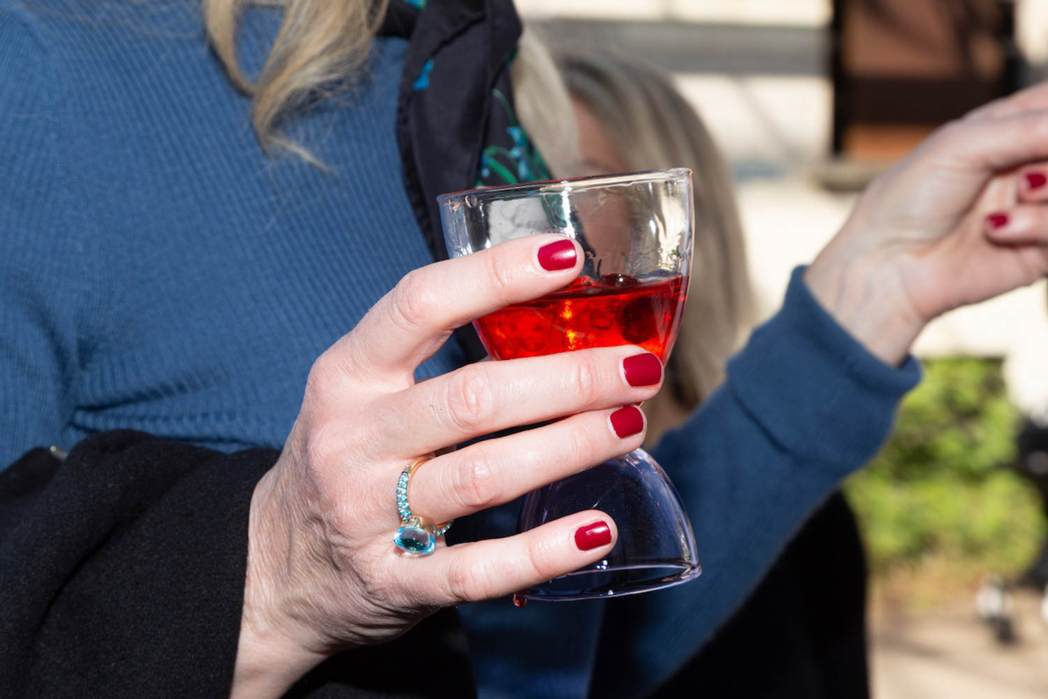a woman holds a Negroni