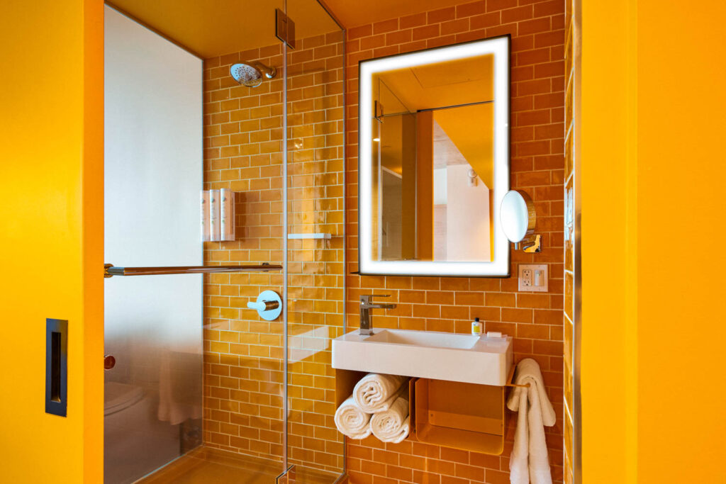 a bathroom with vibrant yellow tile