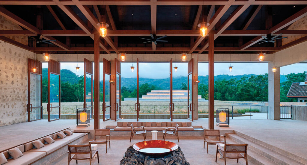 a seating area as part of a tasting room looking out to mountains in the distance