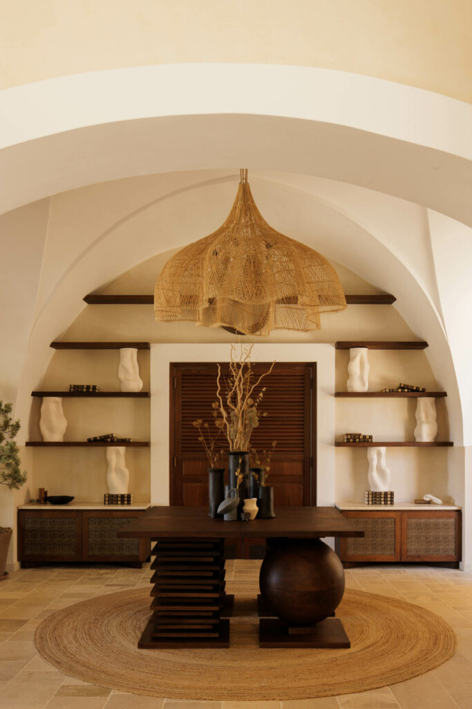 archways lined with shelving and luxurious decor inside Tenuta Negroamaro, an Italian boutique hotel