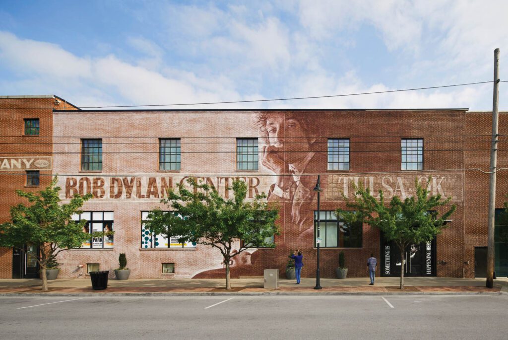 a mural of Bob Dylan on the side of the Bob Dylan Center building