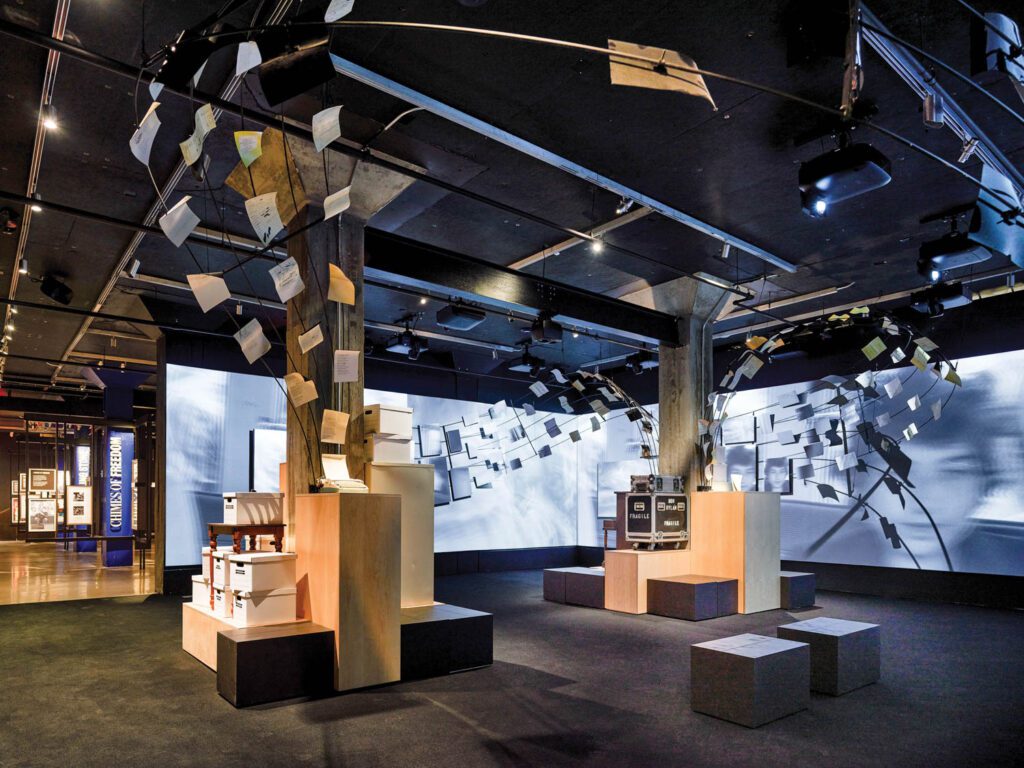 an immersive gallery with paper that looks like it is flying out of typewriters