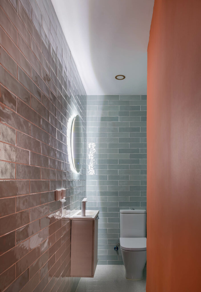 The bathroom features a backlit mirror