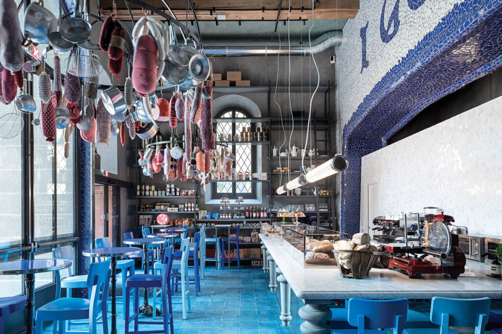 Overlooked by an installation of artificial salami, I Golosi, the hotel’s take-away food hall, is modeled on a classic Italian alimentari.