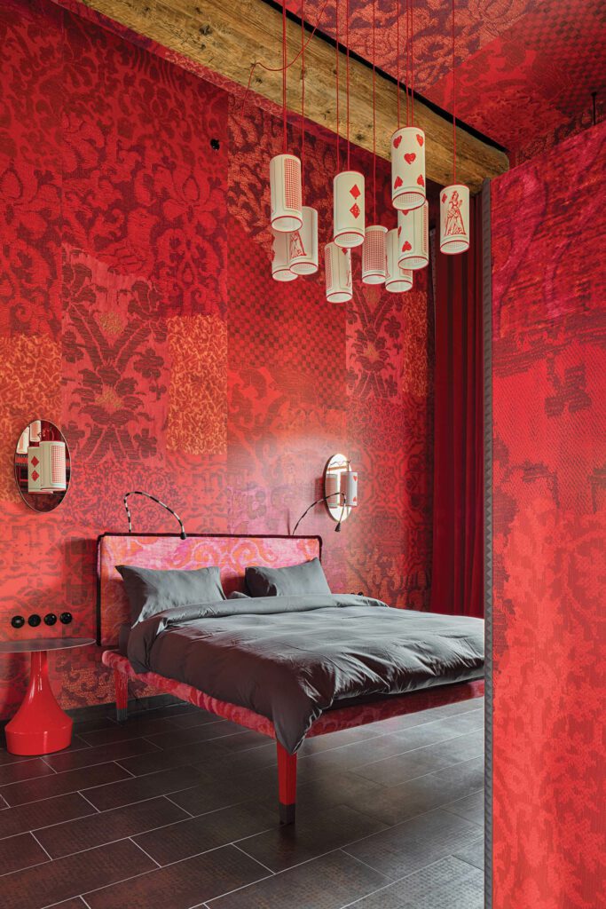The moodier Inferno guest rooms feature custom sconces and pendants bearing playing-card motifs.