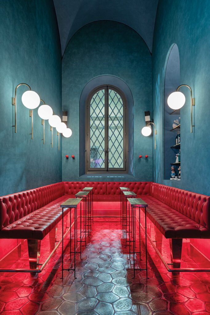 The Companion bar has basalt tile flooring, leather-upholstered banquettes, and iron-and-brass tables, all custom.