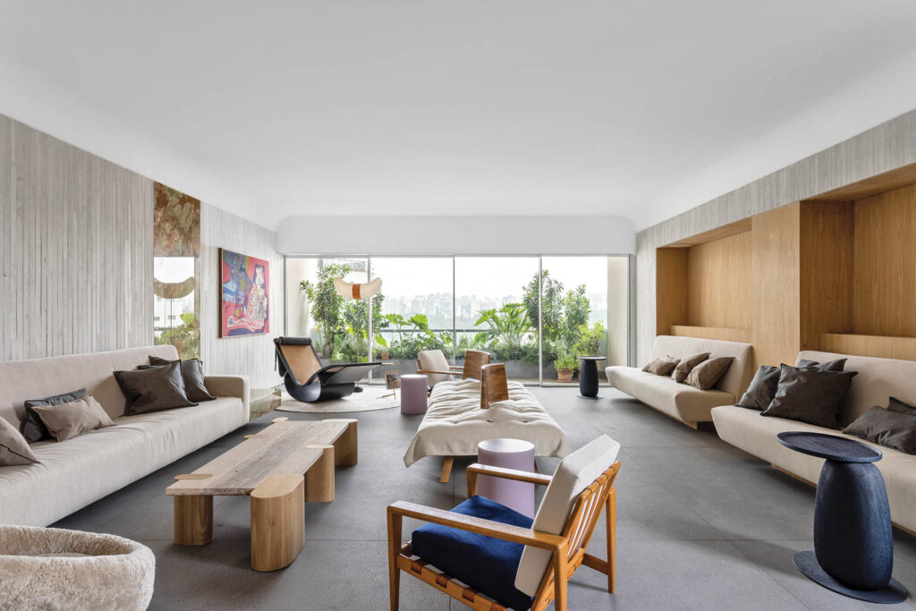 the living room of a Sao Paulo apartment with group seating and a floor to ceiling window