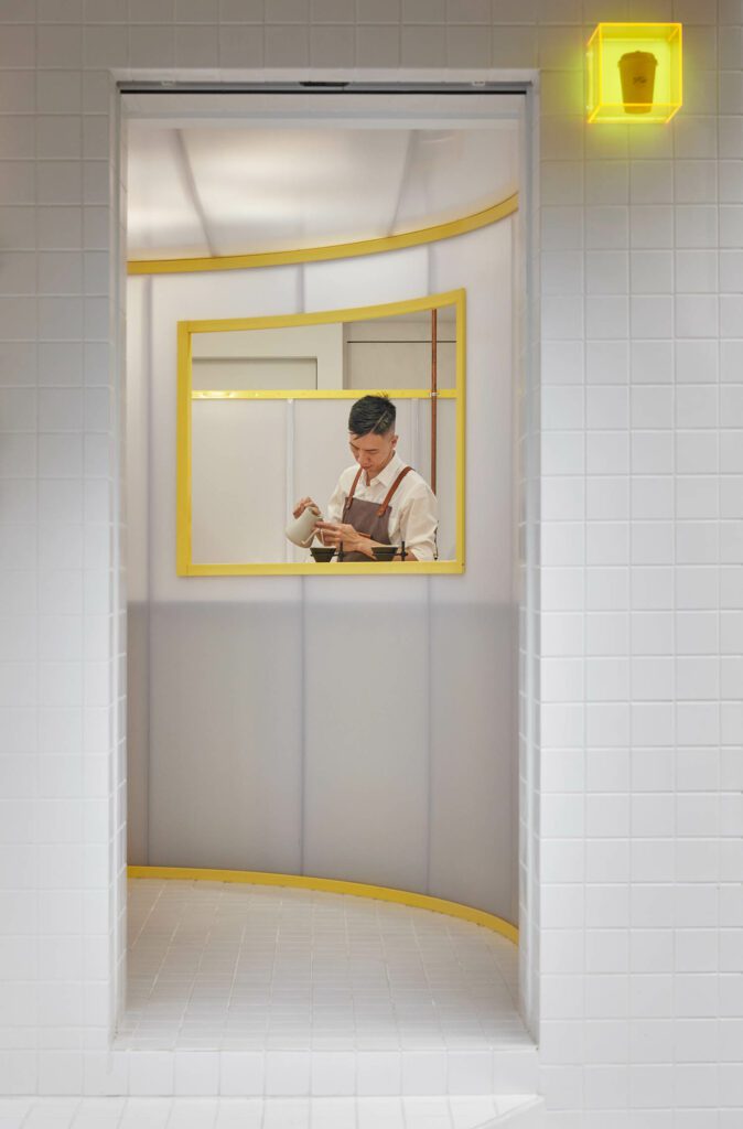 Curving opaque walls fold between tiled walls to create movement and depth.