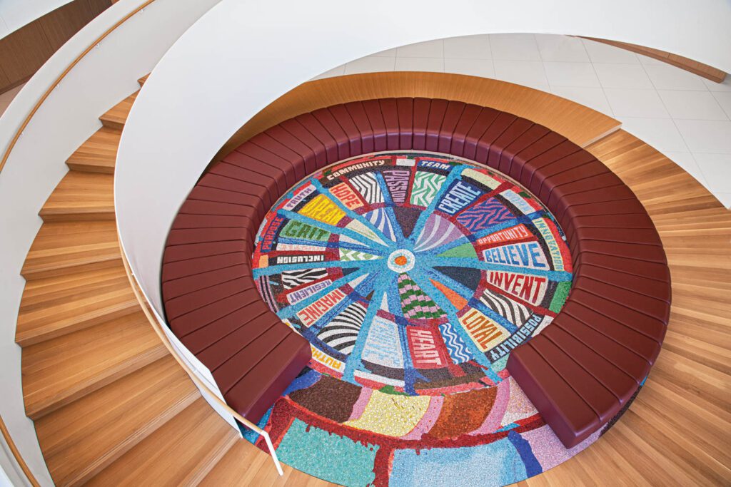 Overhead view of a colorful spiral staircase.