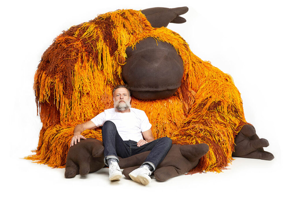 Porky Hefer rests on a piece from his Endangered exhibition