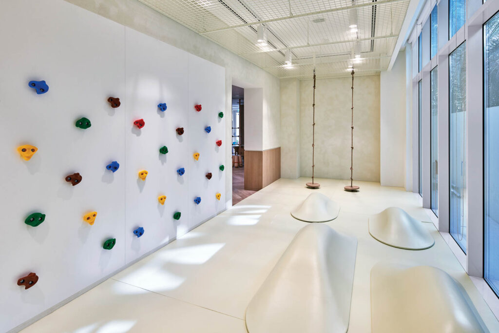a colorful climbing wall for children in the Abu Dhabi office