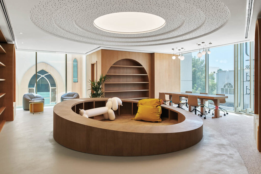 a children's library with an oak round with a bench shaped like a dog