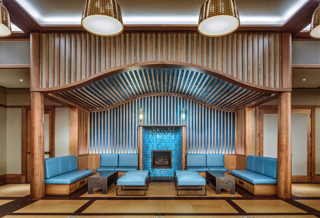blue seating and a blue tiled fireplace under a curved ceiling 