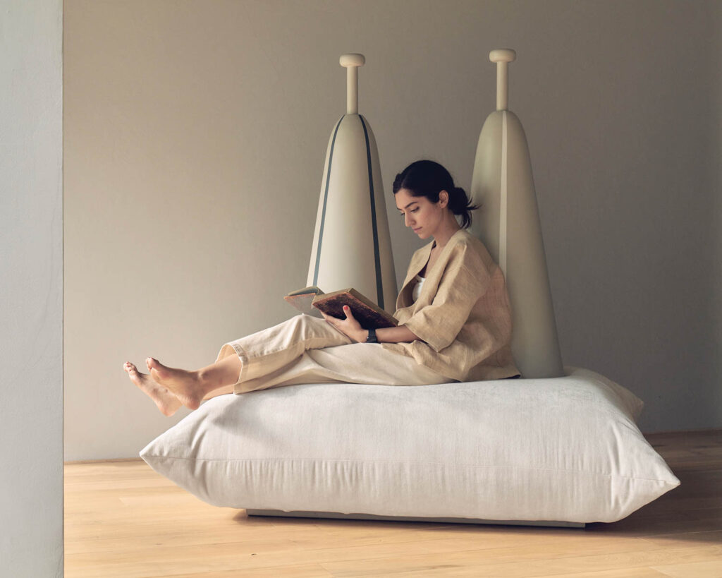 a woman sits on a mil-gah floor cushion