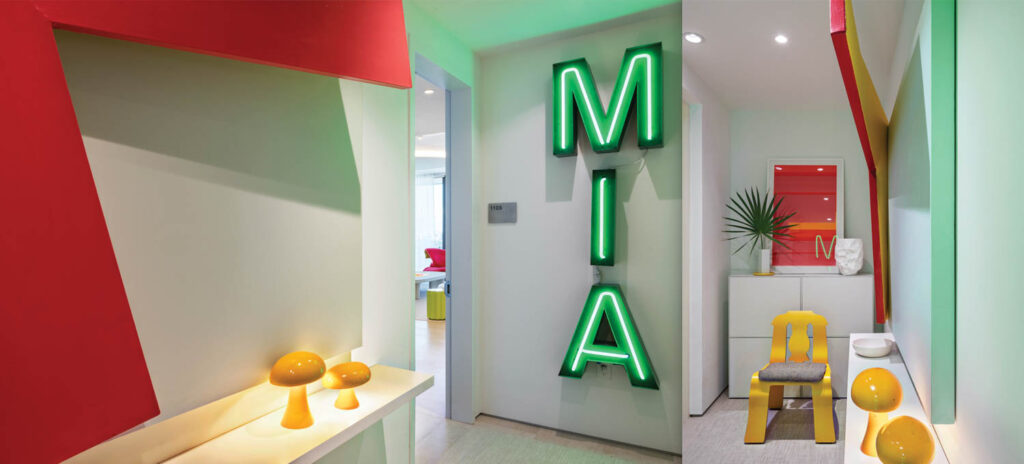 vintage neon signs are seen in the entryway of this apartment