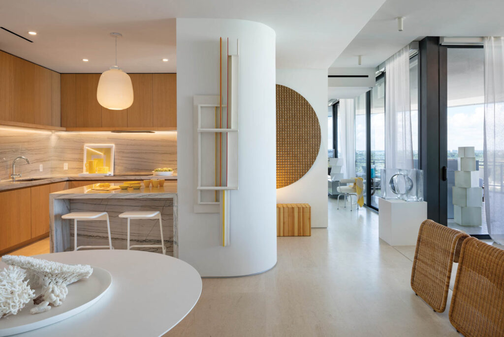 an apartment's minimalist kitchen in whites and light woods