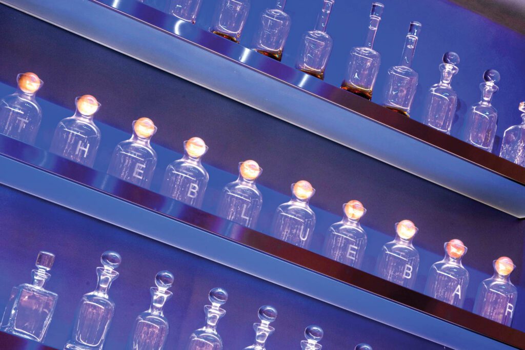 Lettered bottles resembling inkwells in the Blue Bar.