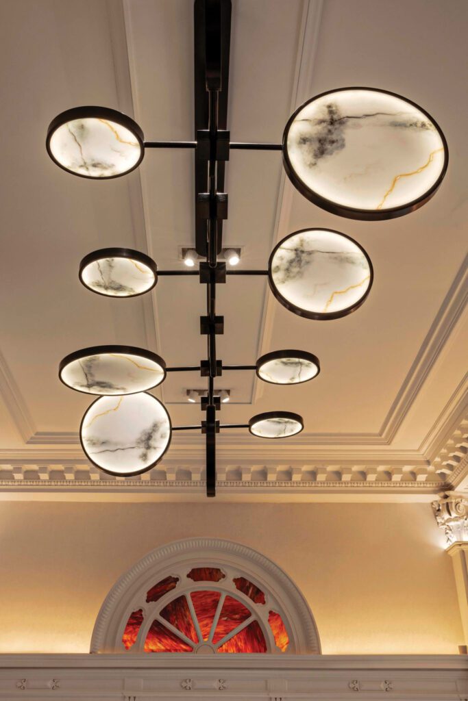 Custom ceiling fixtures in the lobby and restaurant referencing fictional New Yorker character Eustace Tilley.
