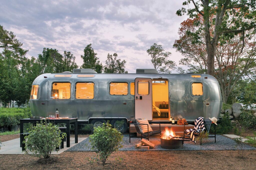 an airstream camper surrounded by trees